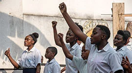 Youth celebrating achievement at Yole Africa empowerment program