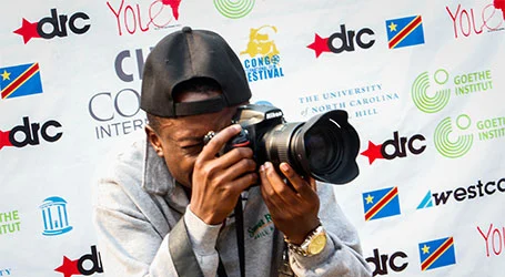 Photography student with camera at international film festival event