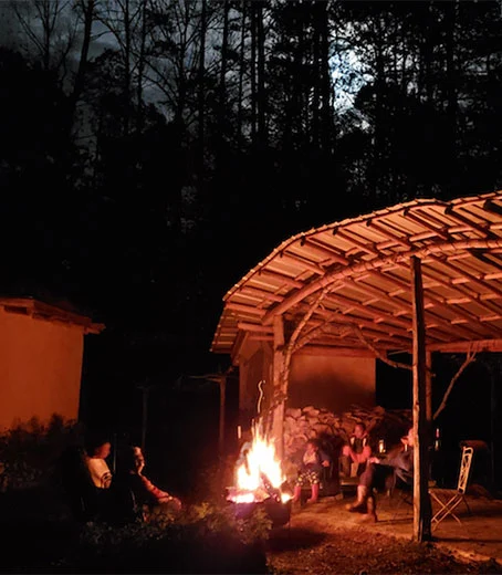 Community gathering around campfire at Yole Africa cultural center in Goma Congo